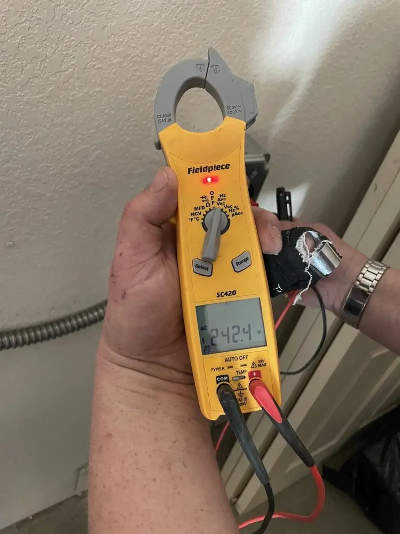 Voltage testing with clamp meter during Recessed Lighting Installation in Magnolia